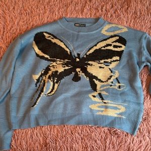 This is a beautiful butterfly cropped sweater that was worn once. In the size L.